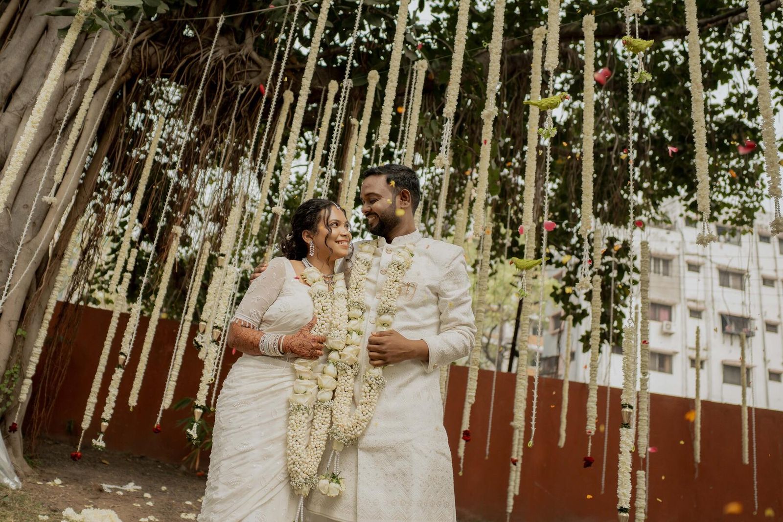 A couple walking together at golden hour on their wedding day